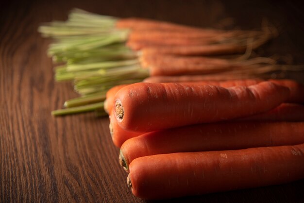 Fresh and sweet carrot on a grey wooden table