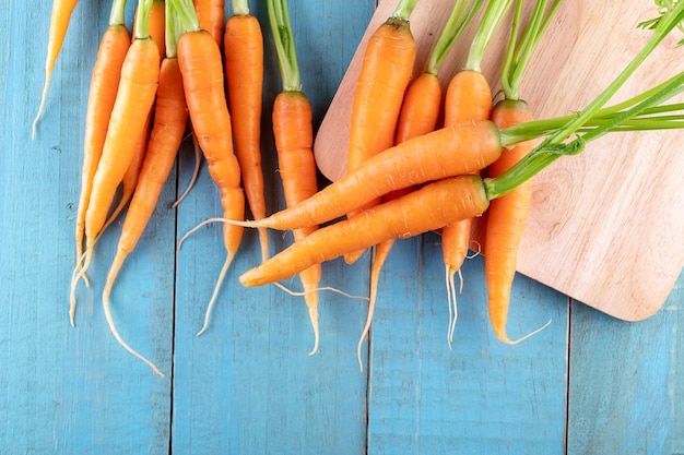 Fresh and sweet carrot on a grey wooden table