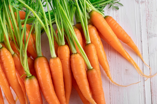 Fresh and sweet carrot on a grey wooden table