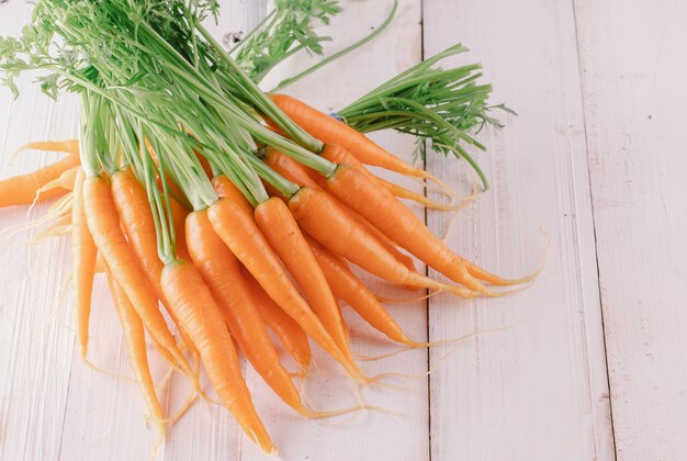 Fresh and sweet carrot on a grey wooden table