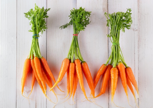 Fresh and sweet carrot on a grey wooden table