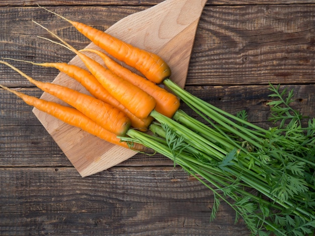 Fresh and sweet carrots on an old wooden table