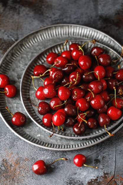 Fresh sweet cherries on table with water drops