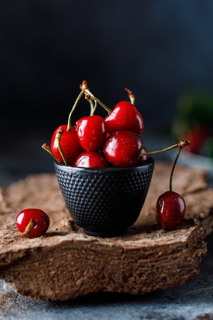 Fresh sweet cherries on table with water drops