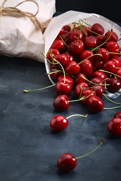 Fresh sweet cherry dark background ecofriendly packaging closeup photo for grocery catalog store