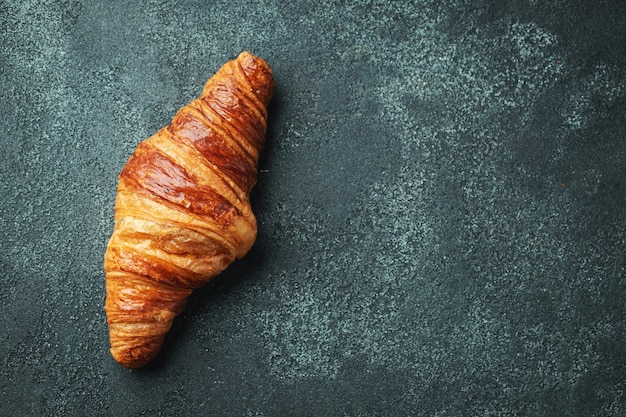 Croissant dolce fresco con burro per colazione.