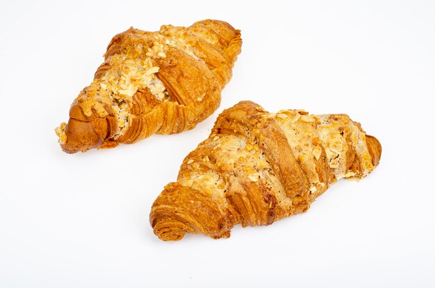 Fresh sweet croissants for breakfast on white. Studio Photo