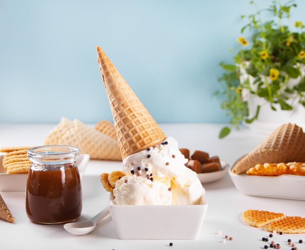 Fresh sweet ice cream with caramel sauce waffles cones Summer food concept