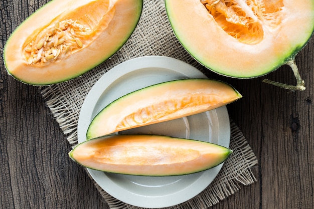 Fresh sweet melon on the old wooden table,top view