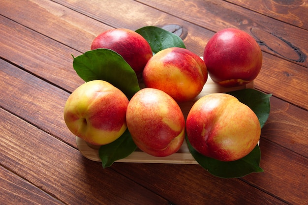 Fresh sweet  nectarines on the wooden table