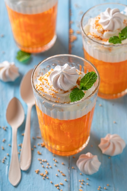 Fresh and sweet orange jelly with whipped cream and tangerines