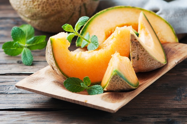 Fresh sweet orange melon on the wooden table