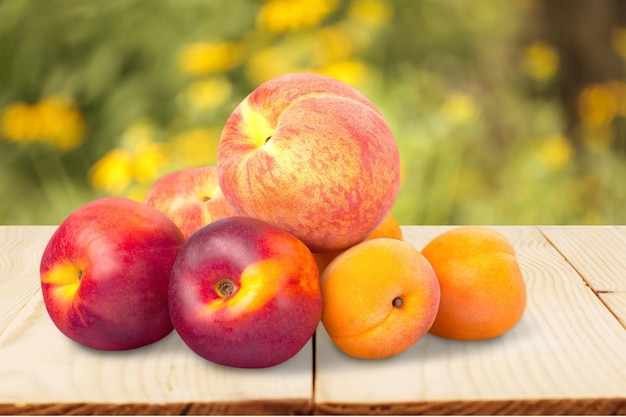 Fresh sweet peaches on a light background