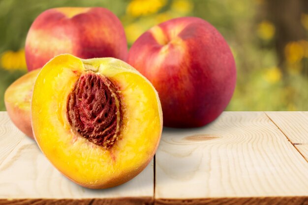 Fresh sweet peaches on a wooden background