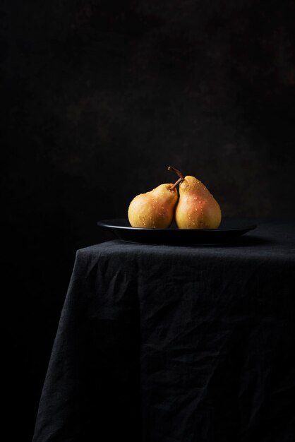 Fresh sweet pears on the dark background, selective focus image