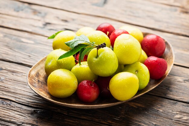 Fresh sweet plums on the wooden table