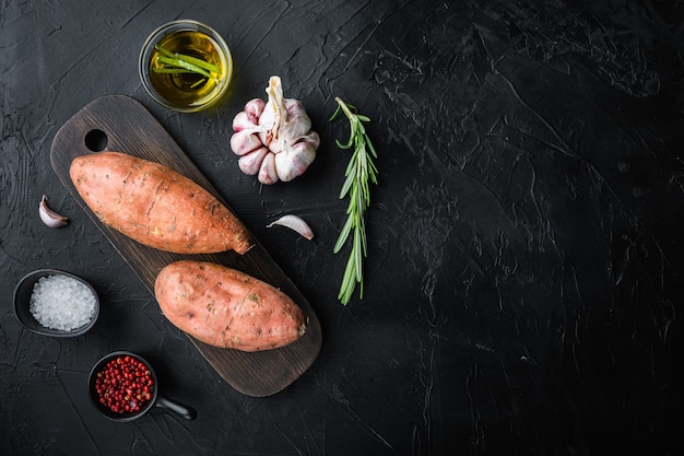 Fresh sweet potatoes on a wooden table