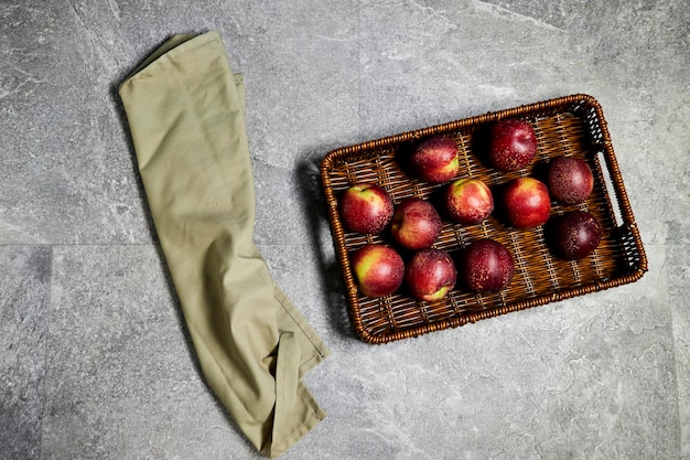 Fresh sweet ripe peaches in basket on gray grunge background