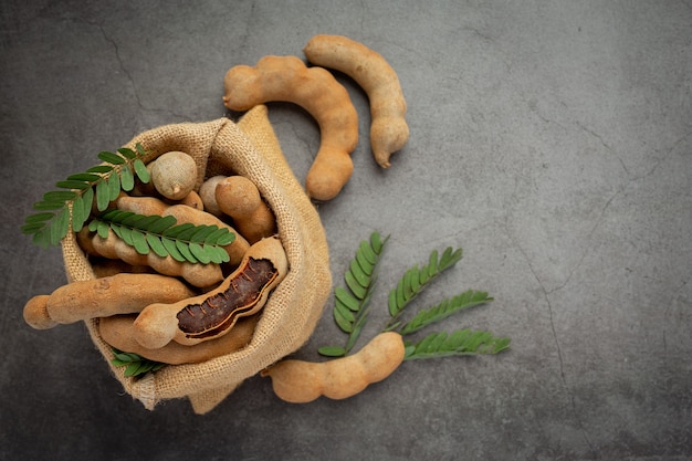 Fresh sweet ripe tamarind on dark surface