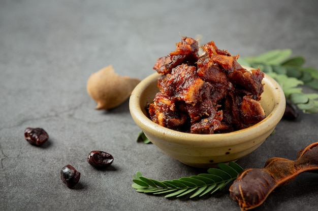 Fresh sweet ripe tamarind on dark surface