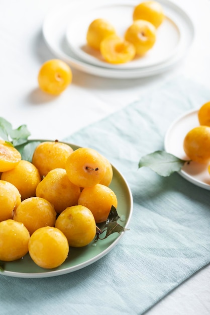 Fresh sweet yellow plums on the table