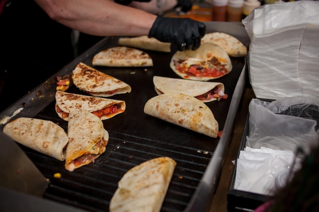 Fresh tacos Chef cooking mexican burito Cook preparing delicious mexican burito at kitchen