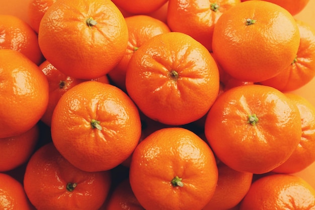 Fresh tangerines background with the multiple water drops top view