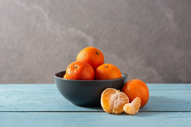 Fresh tangerines on blue wooden table