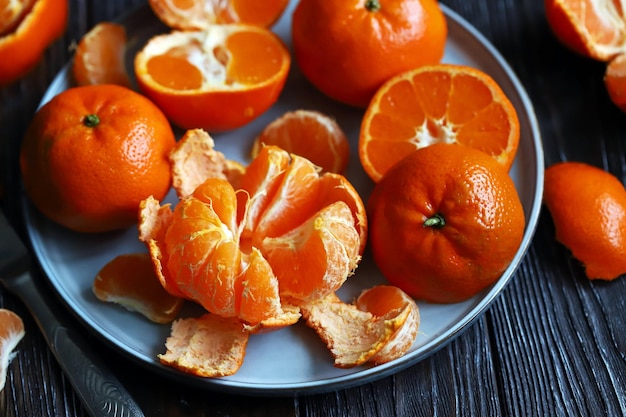 Fresh tangerines on a dark wooden background Citrus