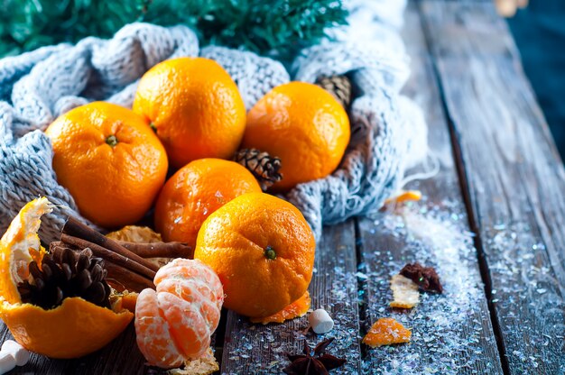 Fresh tangerines on a snow-covered table