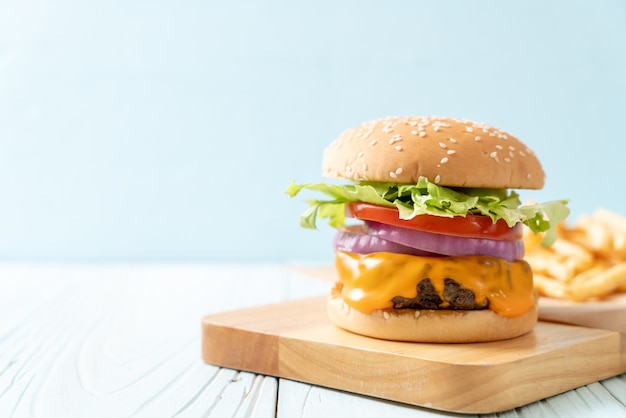 fresh tasty beef burger with cheese and french fries