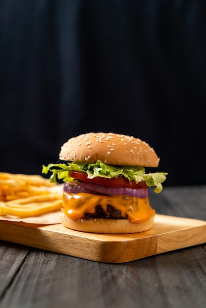 fresh tasty beef burger with cheese and french fries