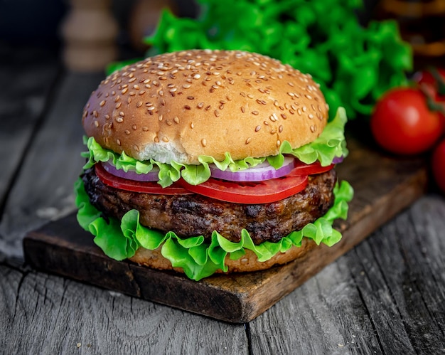 Fresh tasty burger on wood table