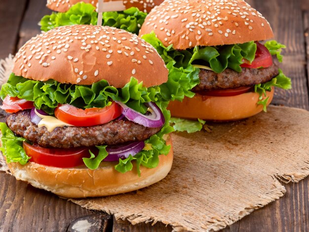 Fresh tasty burger on wood table