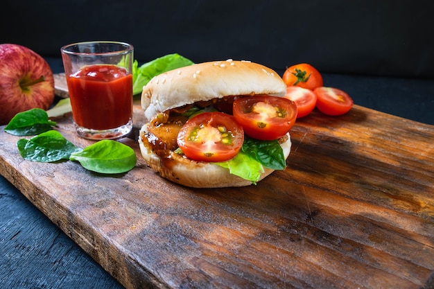 Fresh tasty burger  on   wooden background