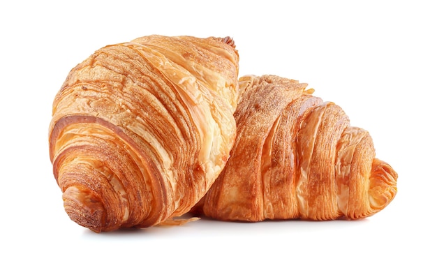 Fresh tasty croissants on white surface