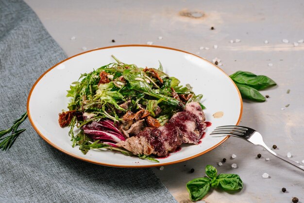 Fresh tasty green salad on the wooden background