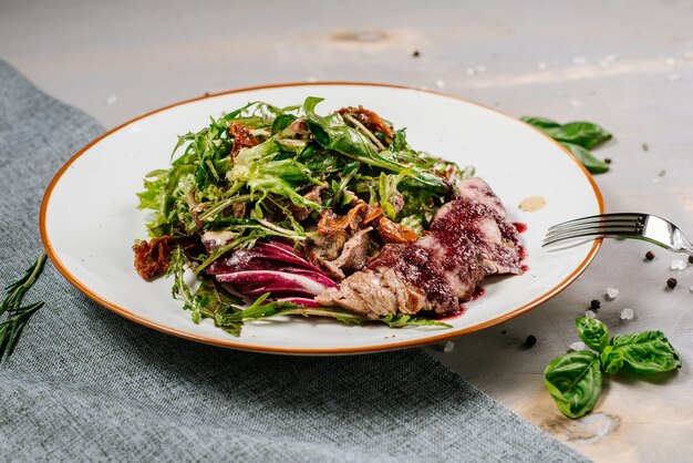 Fresh tasty green salad on the wooden background