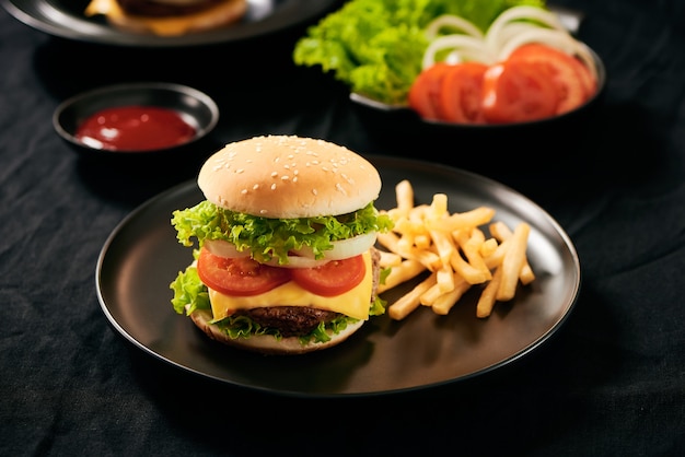 Fresh tasty homemade burger on a black plate