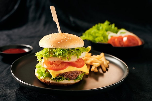 Fresh tasty homemade burger on a black plate