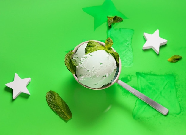 Fresh tasty ice cream ball mint on withe and green background moon and stars