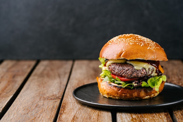 Fresh tasty meat free burger on wooden table. Copy space