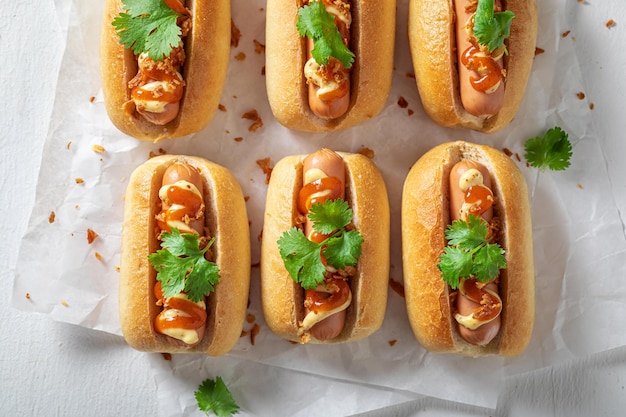 Fresh and tasty mini hot dogs with mustard and herbs