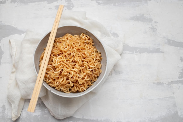 Fresh tasty noodles with vegetables in white bowl