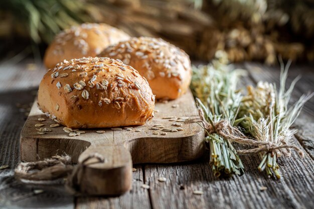 Fresh and tasty oat buns with ears of grains