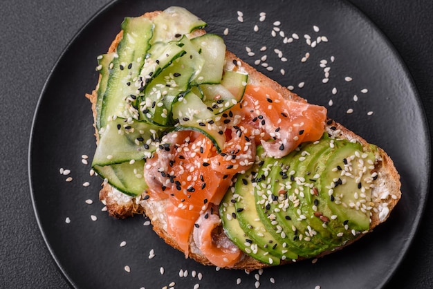 Fresh tasty sandwich with salmon avocado and sesame and flax seeds