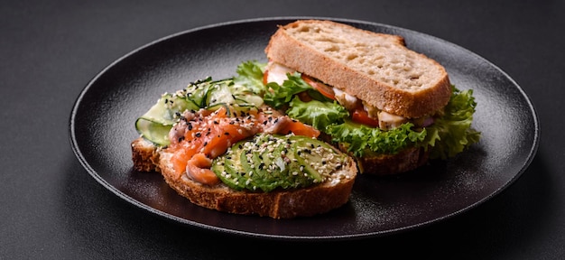 Fresh tasty sandwich with salmon avocado and sesame and flax seeds