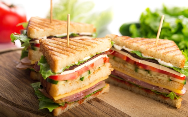 Fresh tasty sandwiches on wooden background