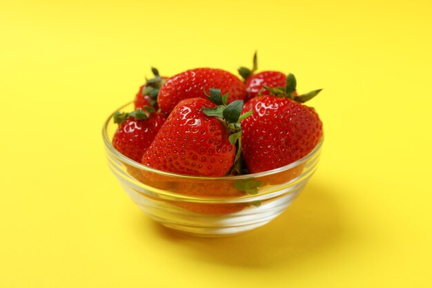 Fresh tasty strawberry on yellow, close up