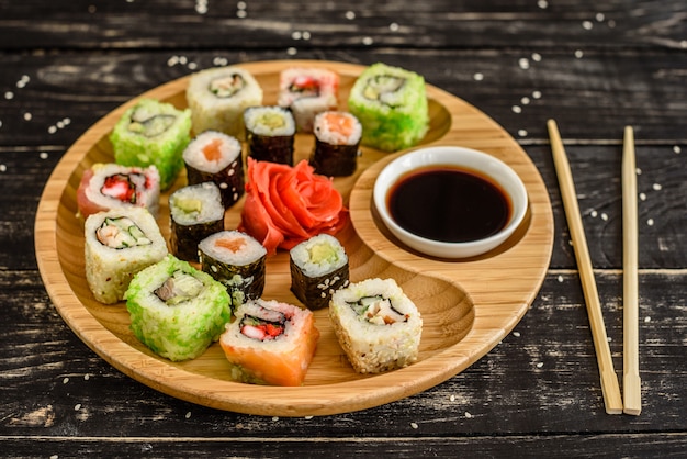 Fresh and tasty sushi on dark background. It can be used as a background